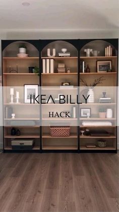 an ikea billy hack in the corner of a room with wooden floors and shelves