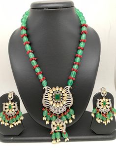 Kundan CZ Pendent Green Maroon Beads Long Mala Necklace Length : 22 Inches; Earring Length : 2 Inches Approx Green Dangling Beads Necklace For Celebration, Green Necklaces With Dangling Beads For Celebration, Festive Green Beads With Dangling Details, Festive Green Beaded Necklace With Dangling Beads, Festive Green Dangling Beads, Green Beaded Necklace With Dangling Beads For Celebration, Festive Green Jewelry With Large Beads, Festive Green Large Beaded Jewelry, Traditional Green Beads For Party