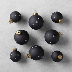 black and gold christmas ornaments on a gray surface