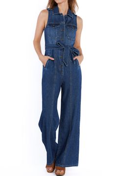 Brassy buttons and sweeping wide legs add character to a fitted denim jumpsuit equipped with handy side pockets. 60" length Front button closure Point collar Sleeveless Chest button-flap patch pockets; side-seam pockets Removable tie belt Unlined 100% cotton Machine wash, tumble dry Imported Dark Wash Wide Leg Denim Jumpsuit With Pockets, Dark Wash Denim Jumpsuit With Wide Legs And Pockets, Denim Blue Bib Front Utility Jumpsuit, Utility Style Denim Blue Bib Front Jumpsuit, Utility Denim Blue Jumpsuit With Bib Front, Spring Utility Style Denim Jumpsuit With Button Closure, Denim Jumpsuit With Bib Front For Workwear, Utility Denim Jumpsuit With Buttons In Medium Wash, Utility Denim Jumpsuit With Buttons