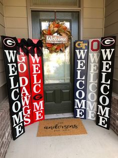 three welcome signs sitting in front of a door