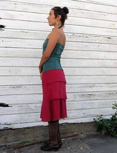 Shape - A nod to the bustle, The Ruffle Butt is a simple A-line design with three tiers of fabric on one side of the garment and a single panel of fabric on the other. Size - Order based on your HIP measurement Fabric Shown - Light Hemp/Organic Cotton Knit Color Shown - Sage (Natural Plant Dye) & Red Fitted Long Skirt With Layered Hem, Tiered Ruffle Skirt For Layering, Fitted Cotton Skirt With Layered Hem, Fitted Tiered Skirt With Layered Hem, Fitted Tiered Ruffled Skirt, Fitted Asymmetrical Skirt For Layering, Fitted Tiered Skirt For Layering, Fitted Tiered Gathered Skirt, Fitted Layered Tiered Skirt