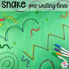 snake pre - writing lines on a green background with crayons and marker pens