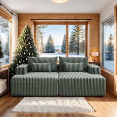 a living room filled with furniture and a christmas tree in front of a large window