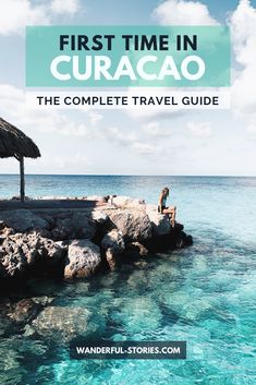 a person sitting on rocks in the ocean with text overlay that reads first time in curaco the complete travel guide