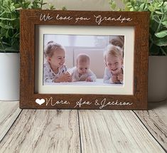 a wooden frame with two babies in it and the words where you're grandpa