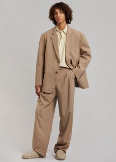 Color: Latte Midweight suiting fabric with light stretch Relaxed straight leg silhouette Pleat front detail Belt loops Pressed crease Slant hip pockets Hook and bar closure Zip fly Lined 96% Polyester 4% Spandex Lining: 100% Polyester Dry Clean By The Frankie Shop. Imported Mens Award Show Fashion, All Tan Outfit, Modern Groomsmen Attire, High Fashion For Men, Grunge Suit Men, Man Fashion 2024, Non Binary Suit, Baggy Suits Men, Suit Man Wedding