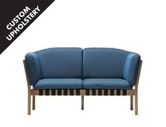 a blue couch sitting on top of a wooden frame