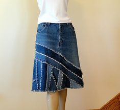 a mannequin wearing a skirt made out of old jeans with fraying on the bottom