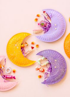 three paper plates with crescents and stars on them sitting next to candy candies