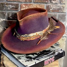 This Size 7 1/4 (23”)Vintage Cowboy Hat Was Rode Hard And Pretty Beaten Upwhich Is Exactly What I Want In A Cowboy Hat! The Vintage Condition With Its Moth Holes And Scuffs, Is The Ideal Element To Create A Hat That Is Rich With Character. I Can Promise That You Alone Will Own This Hatbecause No Two Are Ever Alike. Each Is Reshaped By Hand, Dyed Purple And Rust And Burned By Handand I Currently Have The Dyed Hands To Prove It! I Sewed In An Adjustable Band, So It Fits Smaller Sizes. The Band Is Ranch Hat, Vintage Cowboy Hat, Turkey Feathers, Vintage Cowboy, Vintage Fur, Trade Beads, Prove It, What I Want, Cowboy Hat