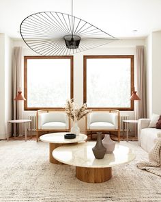 a living room filled with furniture and large windows