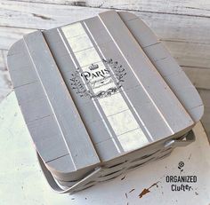 a wooden box sitting on top of a white table