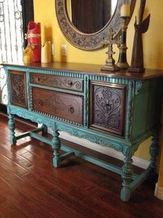 an ornately painted sideboard in a living room