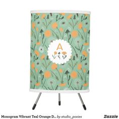 an orange and green flowered lamp shade with the name algon on it's side