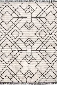 a white rug with black and grey designs on it's edges, in the shape of an arrow