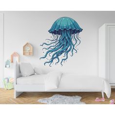 a bedroom with a white bed and a blue jellyfish wall decal