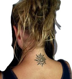 a woman with a sun tattoo on her neck