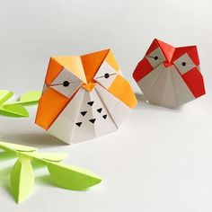 two origami owls sitting next to each other