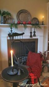 a living room filled with furniture and a fire place covered in christmas decorations on top of a mantel