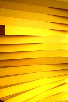 the light shines brightly through the blinds in this room with yellow walls and flooring