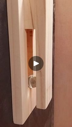 a wooden door handle with a glass in the center and an opening on the side