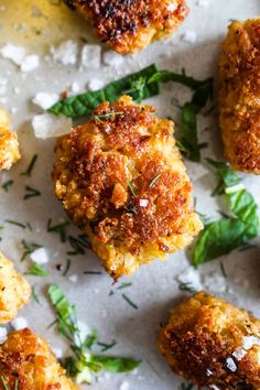 crab cakes with herbs and salt on a sheet of wax paper, ready to be eaten