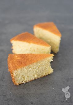 two pieces of white cake sitting on top of a gray counter next to each other