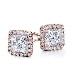 a pair of square shaped diamond earrings with halos on each side and pave set in 18k yellow gold