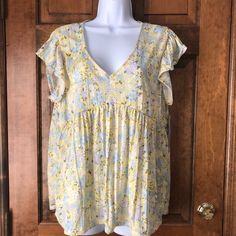 New With Tags; Absolutely Famous; Pullover Top; X-Large; Yellow With Blue, Lilac & White Flowers; Deep V-Neck; Flutter Sleeves; 100% Polyester; Machine Wash & Tumble Dry; Armpit To Armpit 21"; Armpit To Hem 17"; Length 25" Summer V-neck Tops For Daytime, Yellow Flowy Short Sleeve Top, Daytime Floral Print V-neck Tops, Yellow V-neck Top For Beach, Flowy Yellow Tops For Spring, Flowy Yellow Summer Tops, Lilac White, Blue Lilac, Lilac Flowers