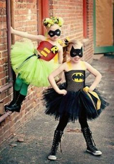 two children dressed up as batman and catwoman