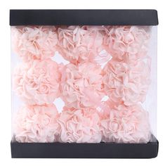 pink flowers are in a black box on a white background and it looks like they have been made out of paper