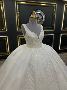 Luxurious Sleeveless Wedding Dress with Deep V-Neckline and Beaded Lace Appliques Elegant White Sleeveless Ball Gown, Elegant Sleeveless White Ball Gown, V-neck Wedding Dress For Debutante Ball With Fitted Bodice, V-neck Wedding Dress With Fitted Bodice For Debutante Ball, Elegant Bridal Dresses With Pearl Embroidery, Pearl Embroidered V-neck Wedding Dresses, White Embellished V-neck Gown, V-neck Wedding Dress With Sweep Train And Fitted Bodice, Wedding Dress With Fitted Bodice And V-neck