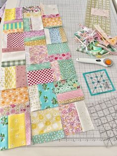 the quilts are laid out on the table ready to be sewn together with scissors