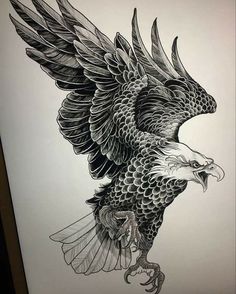 an eagle tattoo design on the back of a shirt