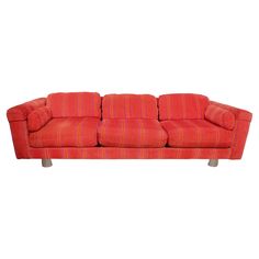 a red striped couch sitting on top of a white floor