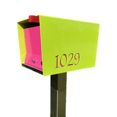 a green and pink mailbox with the number 1039 on it