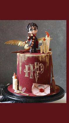 a harry potter birthday cake with an angel figurine sitting on top of it