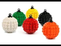 four different colored lego balls are shown in the same color as each other and one is black, white, yellow, red, green, orange