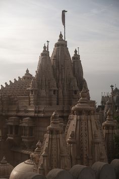 an elaborately designed building with many spires and flags on it's roof