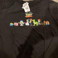 Toy Story Shirt Size Youth Xl Fits Like A Woman’s Small Fun Black Top With Cartoon Print, Black Cartoon Print Fun Top, Black Tops With Cartoon Print, Fun Black Shirt With Character Print, Black Pop Culture Cartoon Print Tops, Black Pop Culture Tops With Cartoon Print, Black Pop Culture Top With Cartoon Print, Black Shirt With Character Print, Disney World Princess