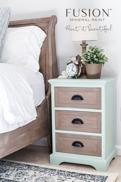 a nightstand with three drawers and a clock on top