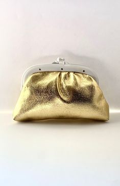 "Vintage small gold clutch for your next evening out! We love this vintage and very retro 60's clutch that can be used as a makeup bag as well. There is tan lining on the inside. Excellent vintage condition with a twist closure. Length: 8.5\" Height: 6.5\" Width: 1.25\" US SHIPPING  FREE International shipping, please see the rate Please add our shop as a ❤ favorite so you can find us again! Our website is minxandonyx.com Www.facebook.com/minxandonyx @minxandonyx, follow us on Instagram Thank you for shopping at Minx and Onyx Vintage!" Classic Gold Pouch Bag, Retro Gold Bags With Gold-tone Hardware, Gold Retro Bags With Gold-tone Hardware, Classic Gold Evening Bag With Removable Pouch, Gold Bag With Gold Clasp For Everyday Use, Gold Bags With Gold Clasp For Everyday Use, Retro Gold Rectangular Evening Bag, Gold Retro Bags, Classic Gold Clutch With Gold-tone Hardware