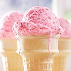 three scoops of pink ice cream sitting on top of each other