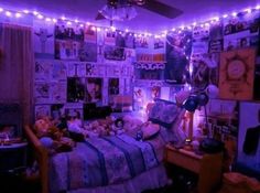 a bedroom with purple lights and pictures on the wall