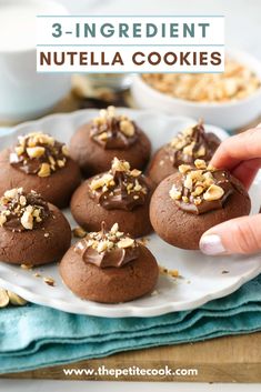 chocolate nutella cookies on a white plate with walnuts in the background and text overlay reading 3 - ingredient nutella cookies