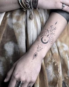 a woman's arm with a tattoo on it and an arrow in the middle