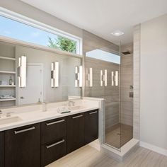 a large bathroom with two sinks and a walk in shower