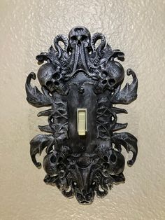 an ornate light switch cover in the shape of a lion's head