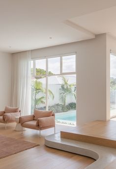 a living room with couches, chairs and windows